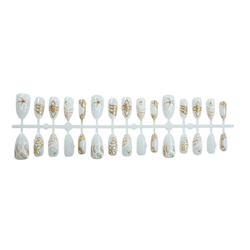 Artificial nail set with luxurious gold embellishments and elegant natural motifs Bowlift