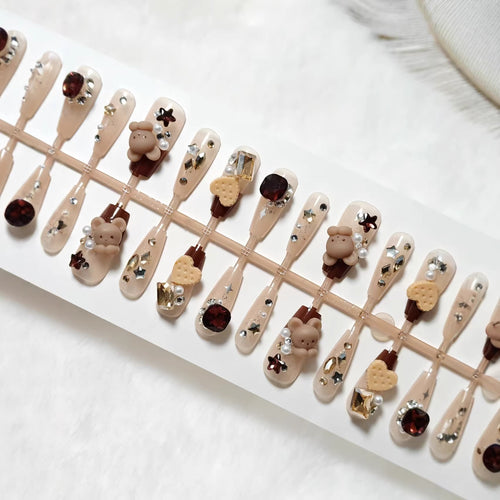Creative acrylic nails with animal motifs and glitter accents Bowlift