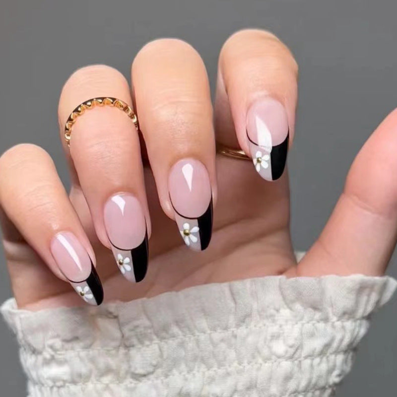 Artful nail art with elegant black-and-white design and floral accents Bowlift