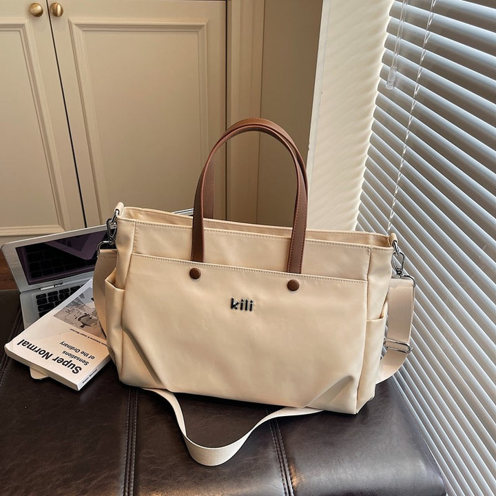 Shopping bag with comfortable carrying system and practical outer pockets Bowlift