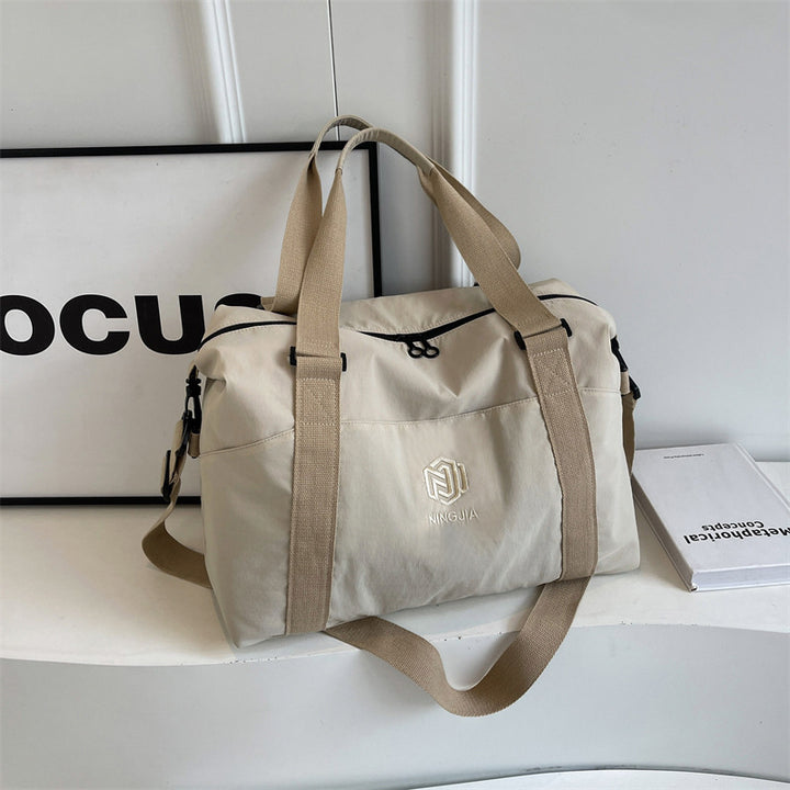 Sporty tote bag with multiple compartments and adjustable straps Bowlift