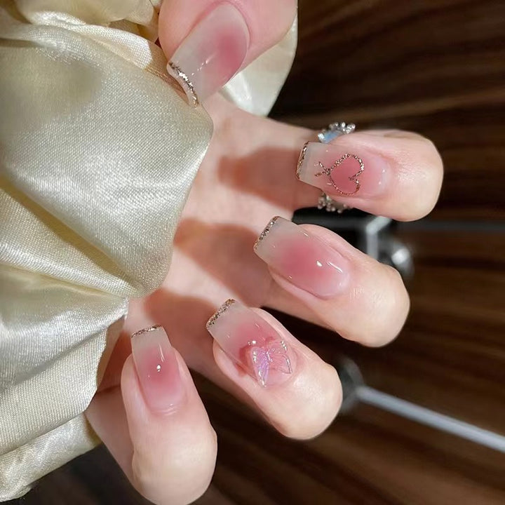 Artistic acrylic nails with heart and butterfly motifs Bowlift