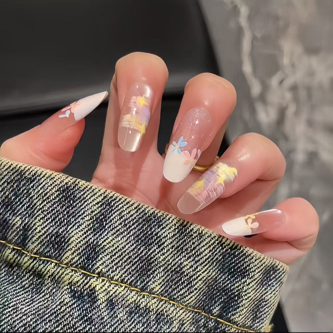 Artificial nails with delicate floral accents and glitter effects Bowlift