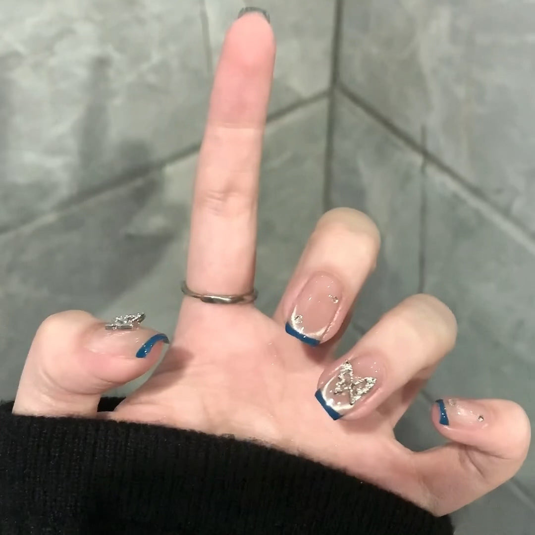 Artificial nails with trendy French tips and decorative glitter accents Bowlift