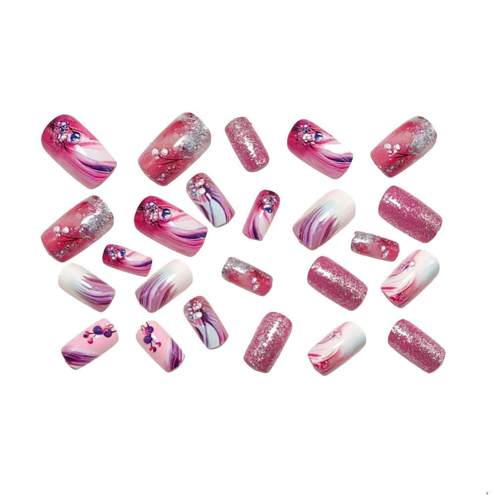 Glamorous artificial nails with delicate flower design and glitter accents Bowlift