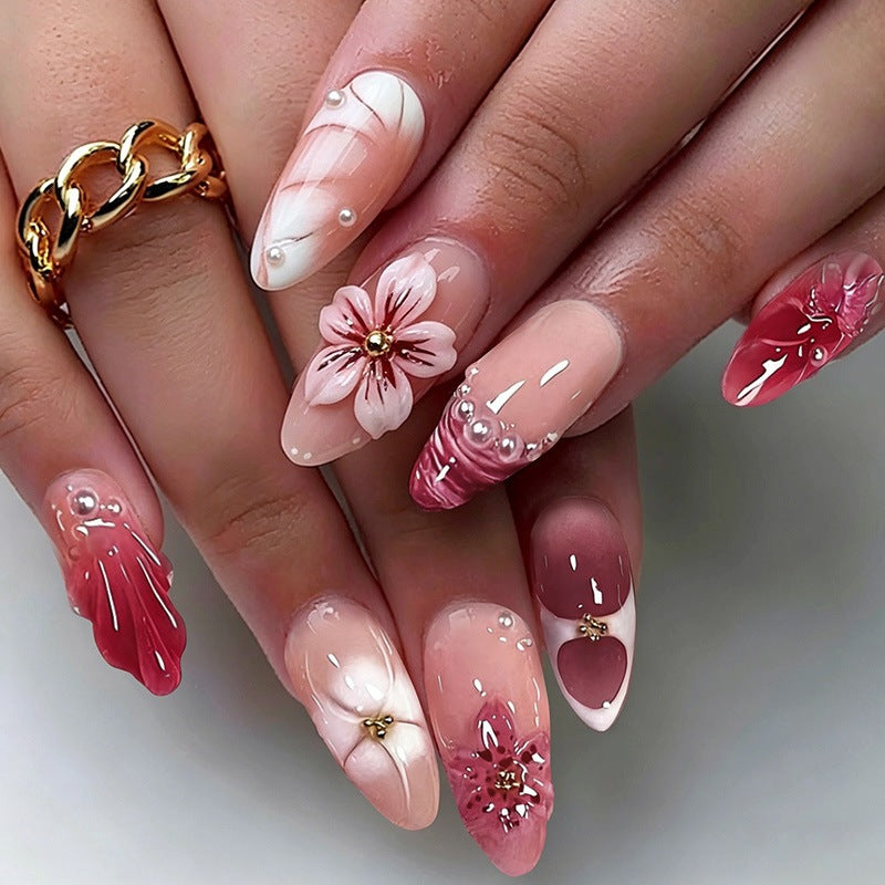 Creative acrylic nail set with floral accents and glitter decorations Bowlift