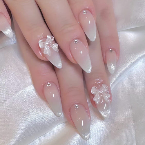Elegant Stiletto Nails with Glitter and Bow Accents Bowlift