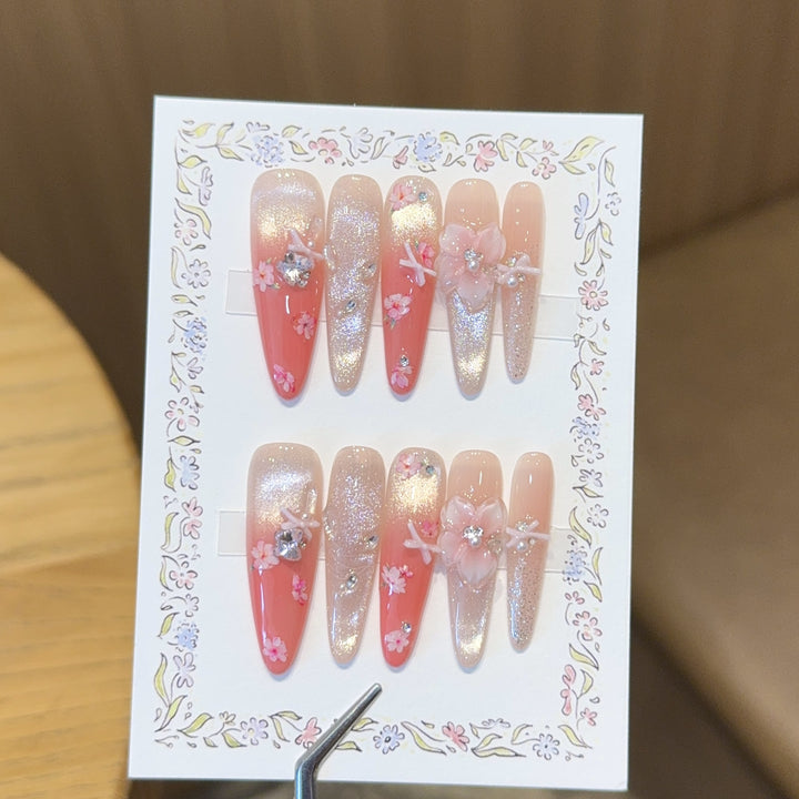 Artificial nails with floral embellishments and glitter effects Bowlift