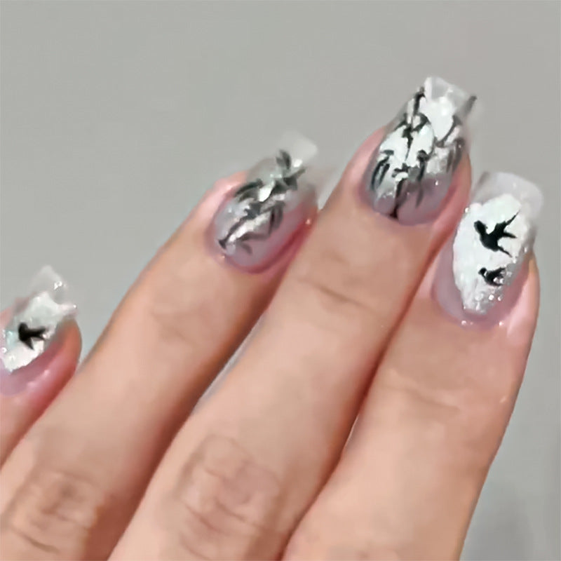 Handcrafted acrylic nails with decorative bird motifs Bowlift