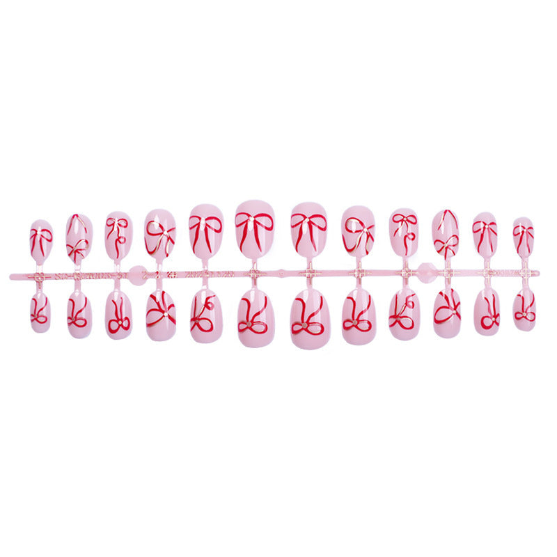Artificial nail design with bow motifs Bowlift