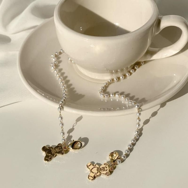Playful pearl necklace with gold pendants Bowlift