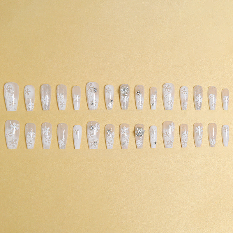 Artificial nail set with frosty snowflake design and sparkling 3D applications Bowlift