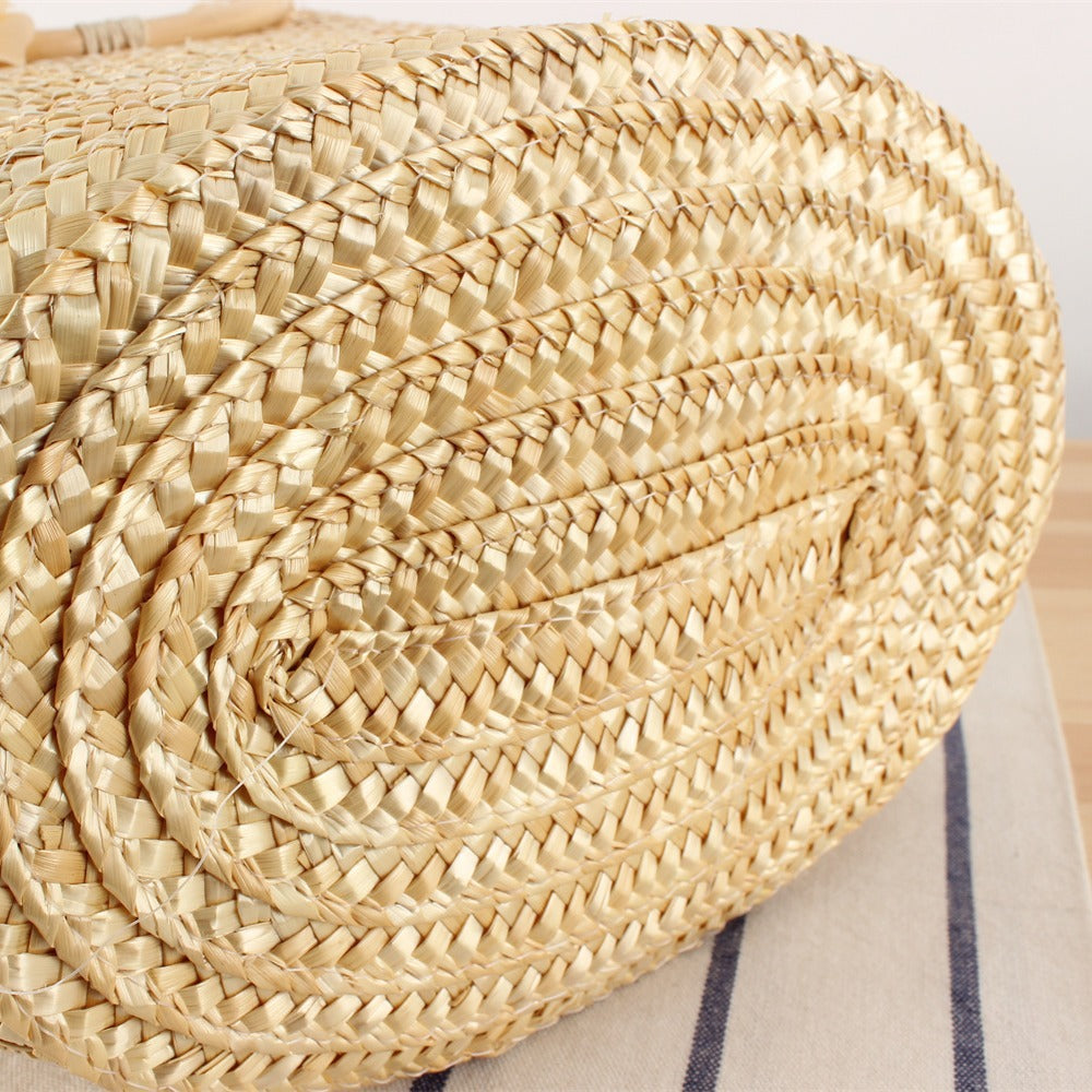 Braided straw bag with floral accent Bowlift