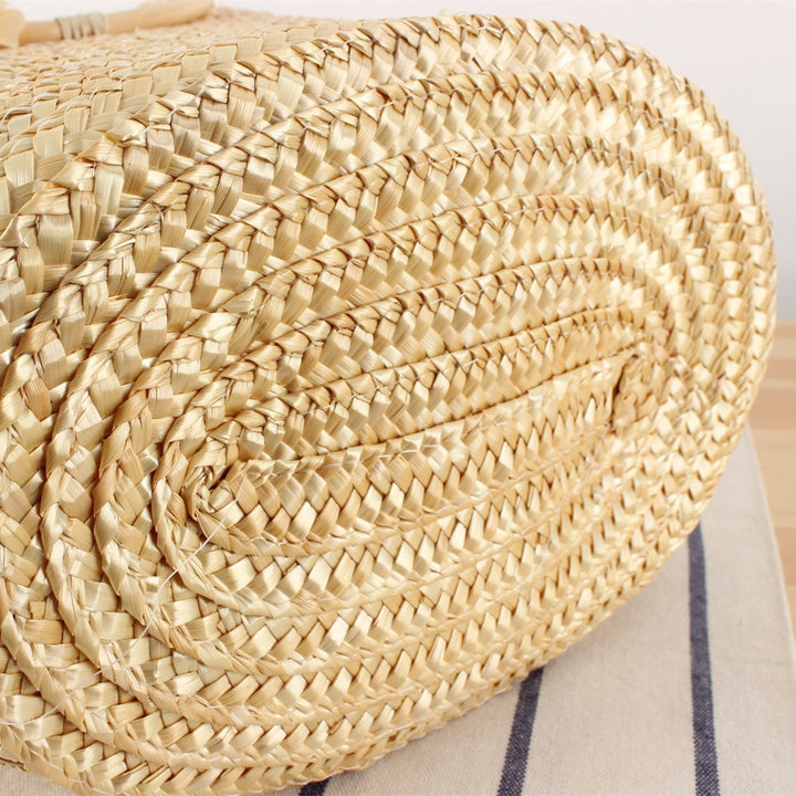 Braided straw bag with floral accent Bowlift