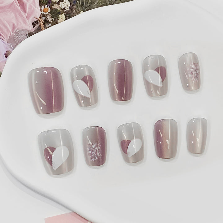 Artistic acrylic nails with heart-shaped accents Bowlift