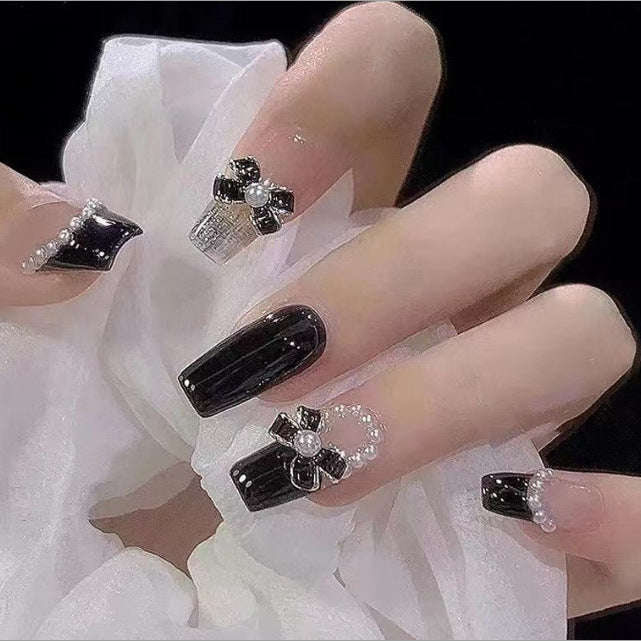 Artistic Nail Art with Glitter and Flower Applications Bowlift
