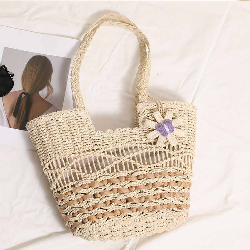 Braided basket bag with decorative flower appliqué Bowlift