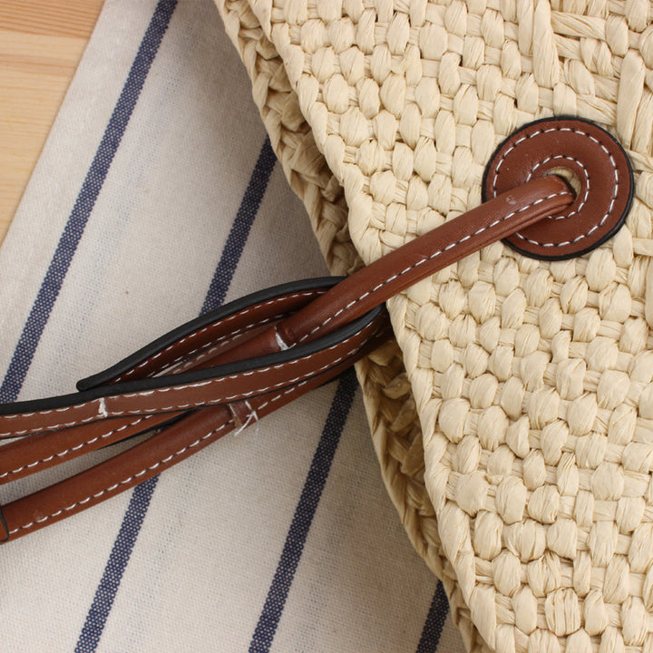 Beach bag made of handcrafted natural material with sturdy leather handle Bowlift