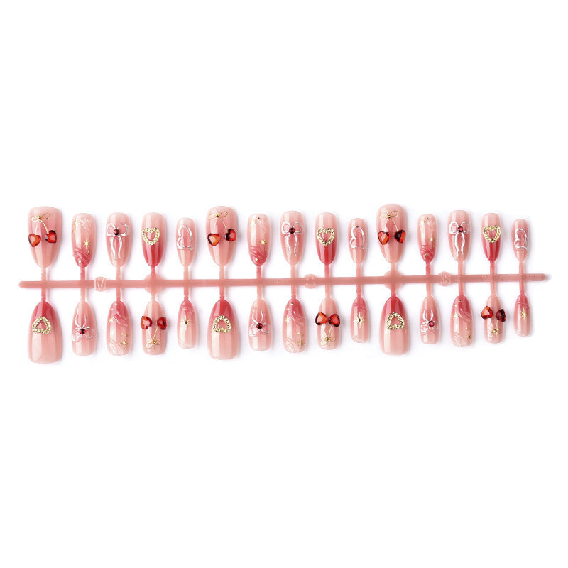 Decorative artificial nails with romantic heart and bow motifs Bowlift