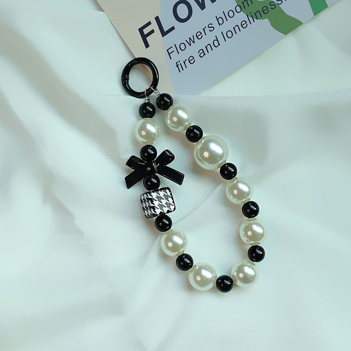 Elegant Pearl and Black Bead Charm Bracelet Bowlift