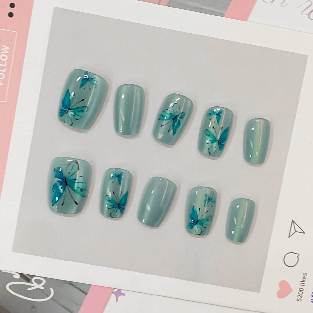 Artistic acrylic nails with butterfly motif Bowlift