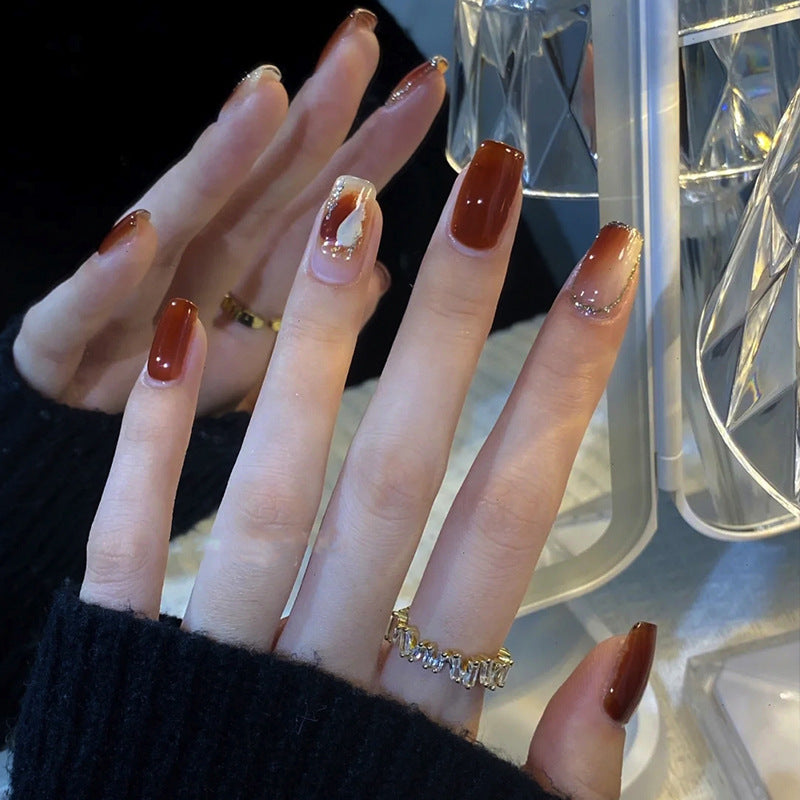 Elegant Glossy Press-On Nails with Gold Glitter Accents Bowlift