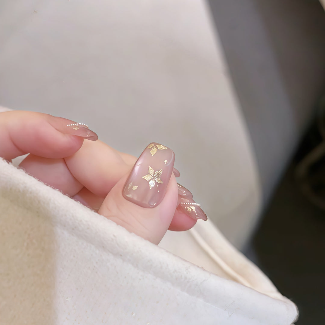 Artificial nails with elegant gold designs Bowlift