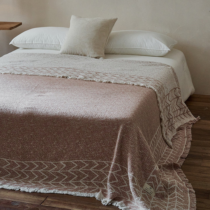 Woven throw blanket with fringes and natural texture