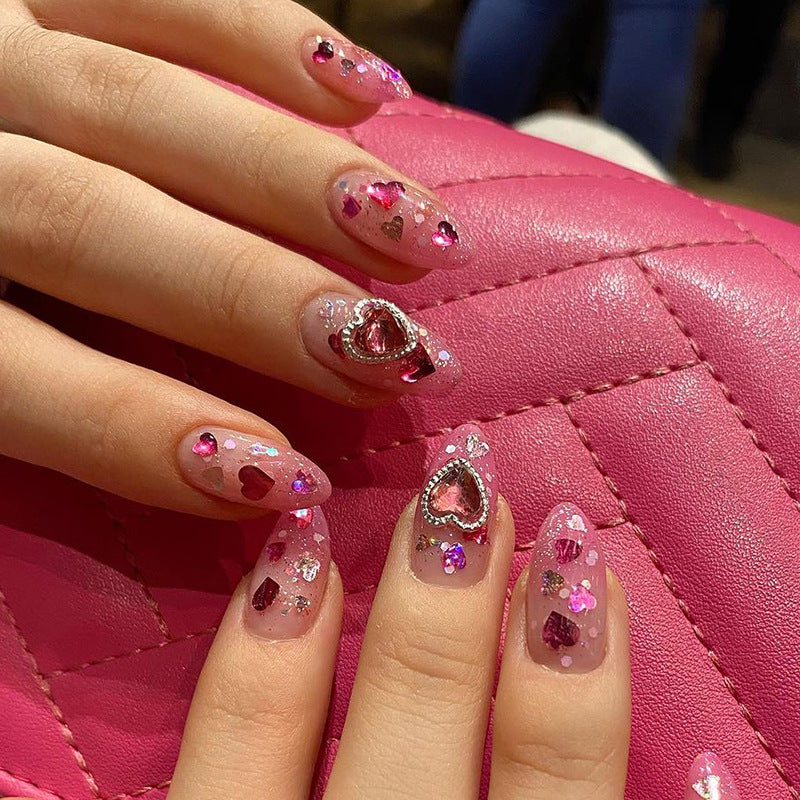 Artful nail art with playful heart designs and glitter Bowlift