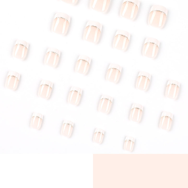 Artful nail extensions with elegant French tip and gold accents Bowlift