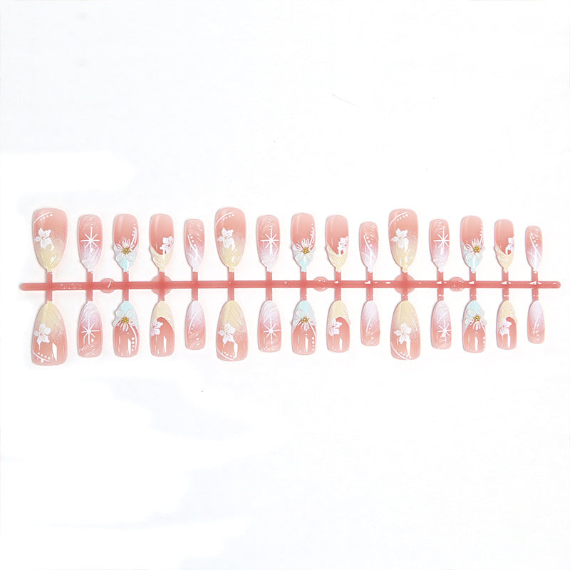 Artificial nail set with intricately detailed floral designs and shine accents Bowlift
