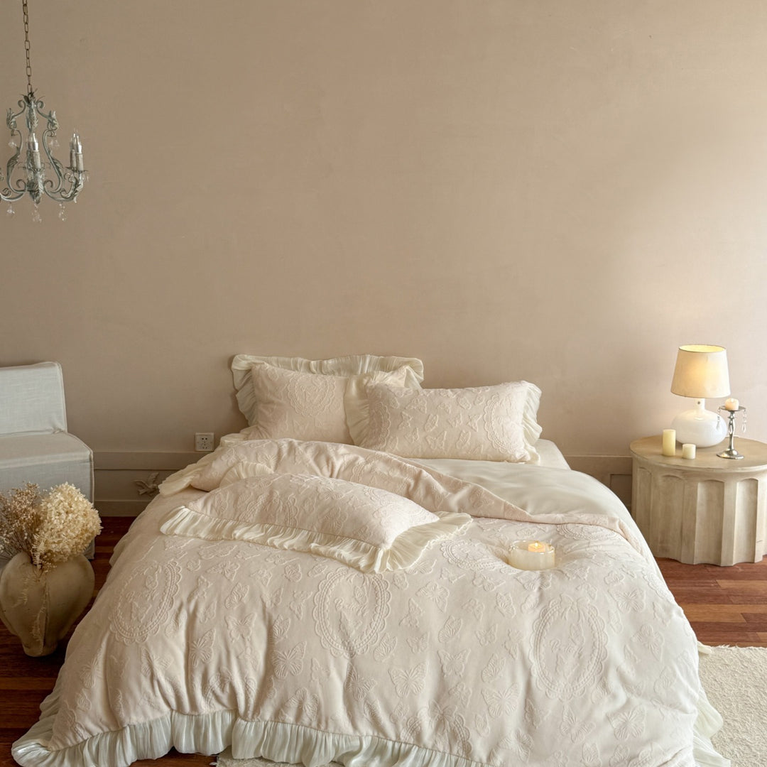 Bedding set with quilted butterfly embossing and romantic ruffle hem