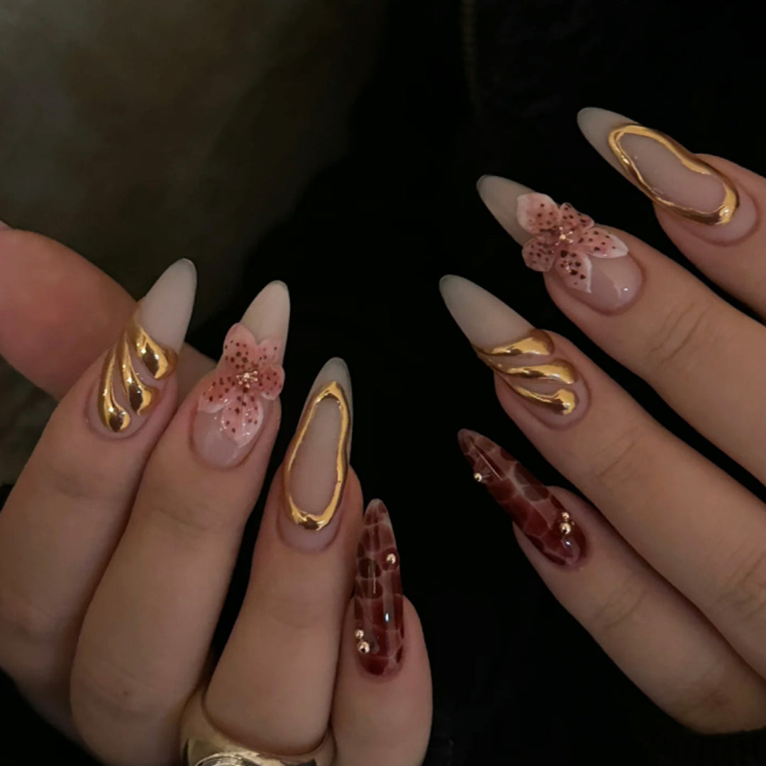 Artful stiletto nails with elegant floral designs and glitter accents Bowlift