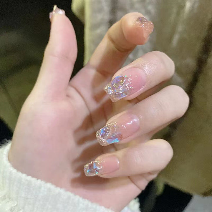 Glamorous artificial nails with heart design and glittering accents Bowlift