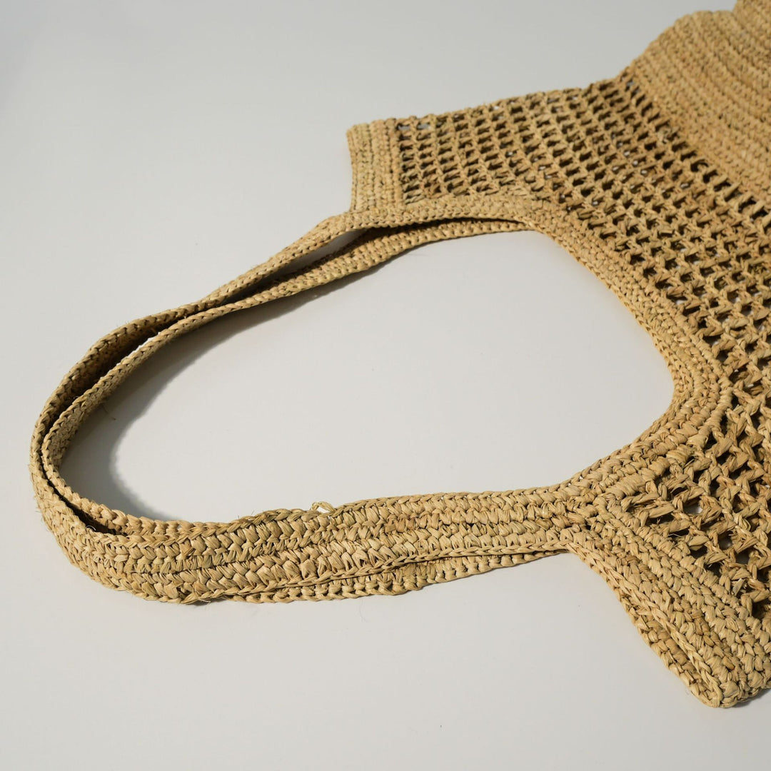 Hand-knotted raffia bag with generous interior Bowlift