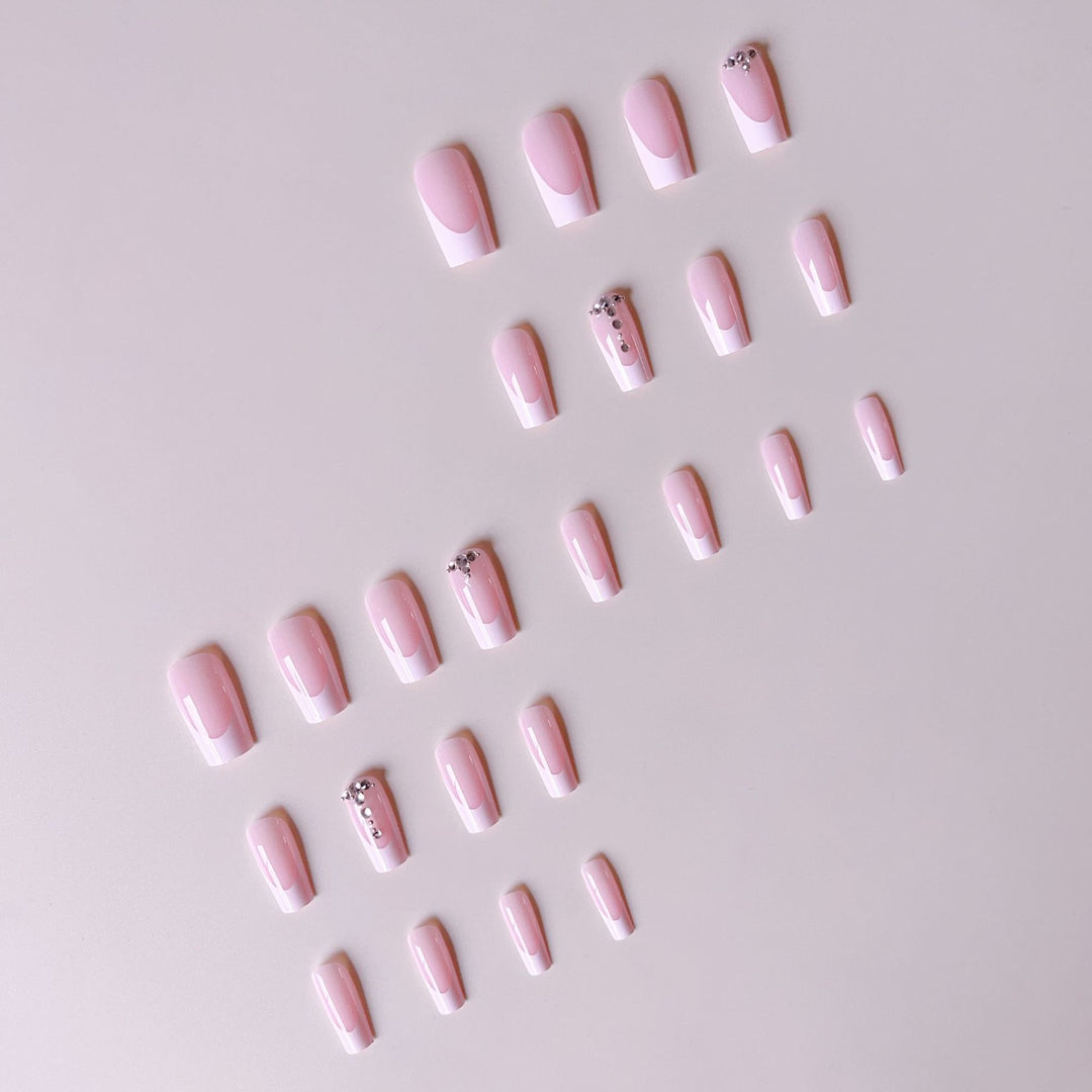 Acrylic nail set with elegant French tips and sparkling rhinestone accents Bowlift