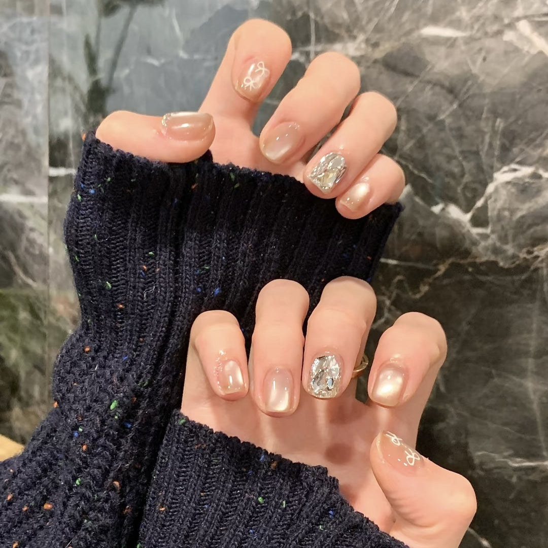 Elegant artificial nails with shimmering glitter and floral details Bowlift