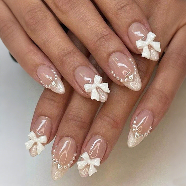 Artificial nail set with elegant bows and pearl embellishments Bowlift