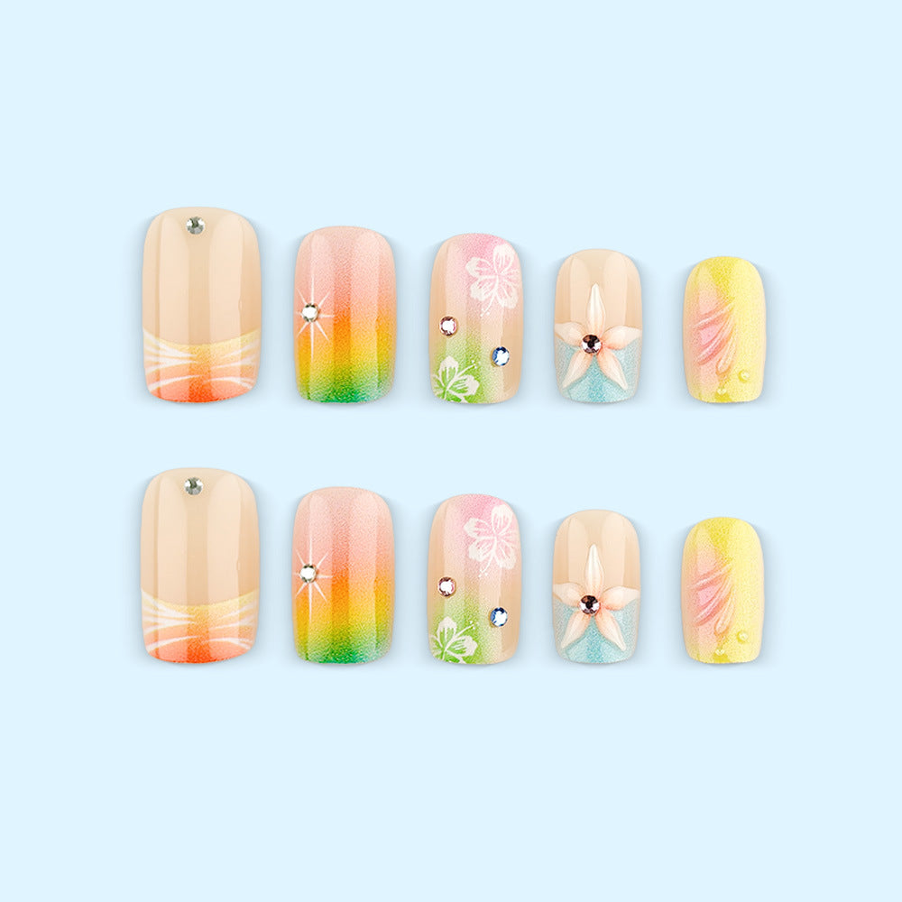 Artificial nails in vibrant floral design with glitter accents Bowlift