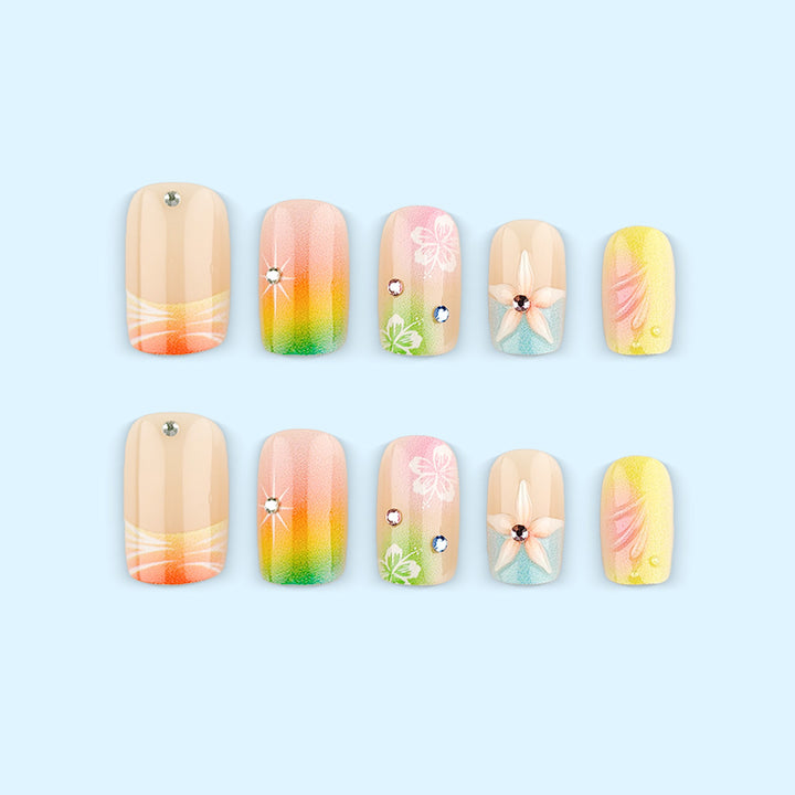 Artificial nails in vibrant floral design with glitter accents Bowlift