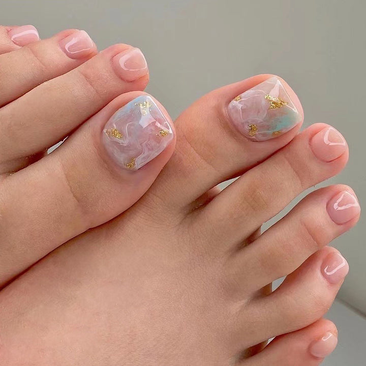 Artful toenail art with elegant marble and gold accents Bowlift