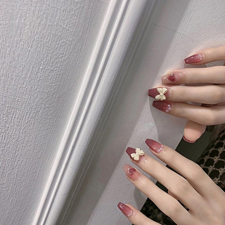 Artificial nails with heart accent and glamorous decorations Bowlift