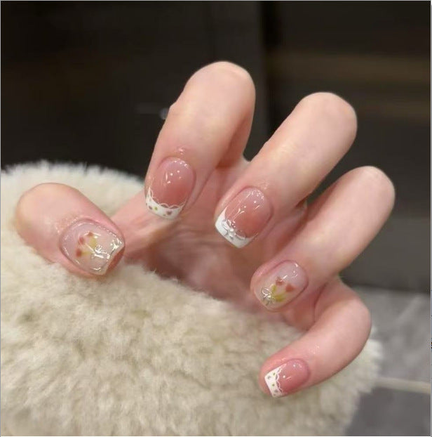 Artistic Nail Art with Glitter and Flower Applications Bowlift