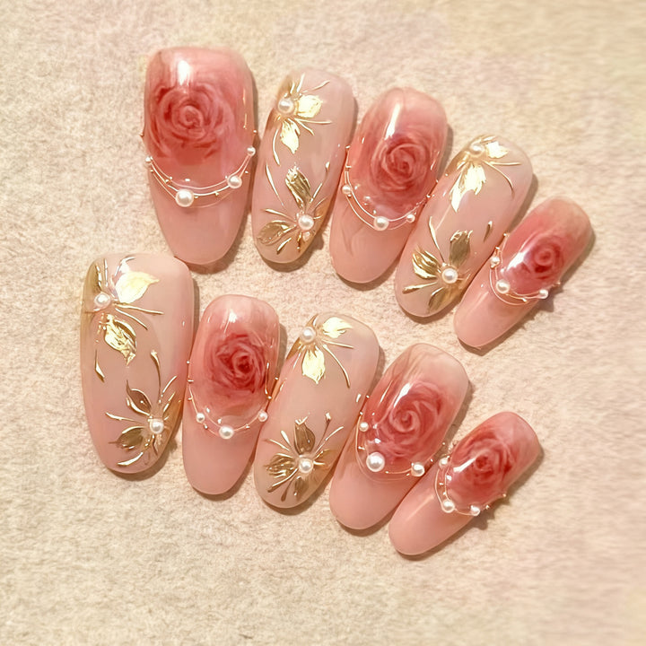 Artificial nail set with glamorous floral designs and creative glitter accents Bowlift
