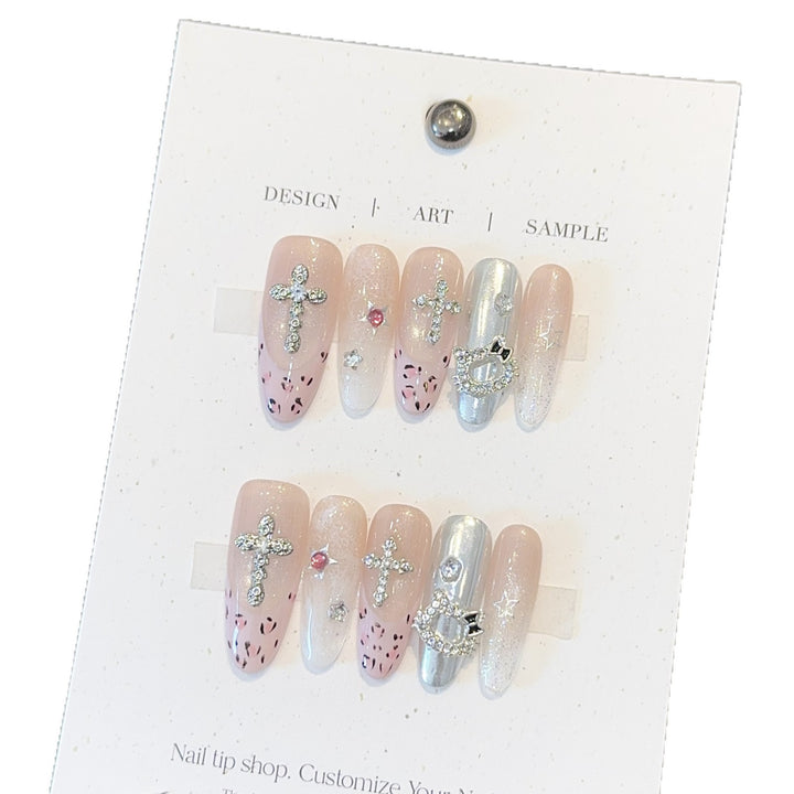 Artificial nails with sparkling rhinestones and cross motifs Bowlift