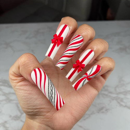 Artful Nail Art with Festive Bows and Christmas Motifs Bowlift