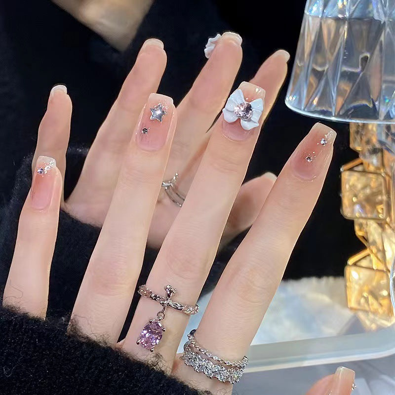 Artistic nail tips with floral and glittering accents Bowlift
