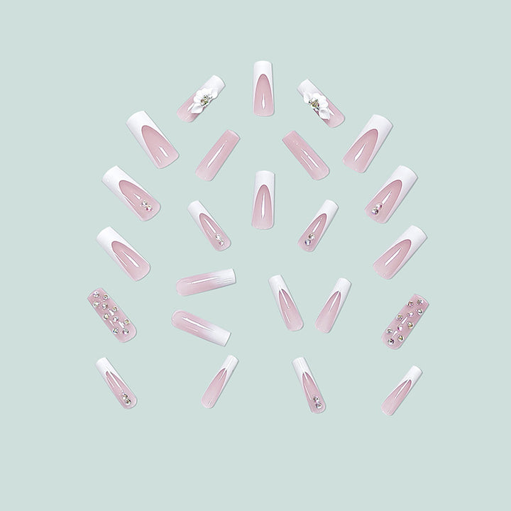 Artful stiletto nails with floral accents and rhinestone details Bowlift
