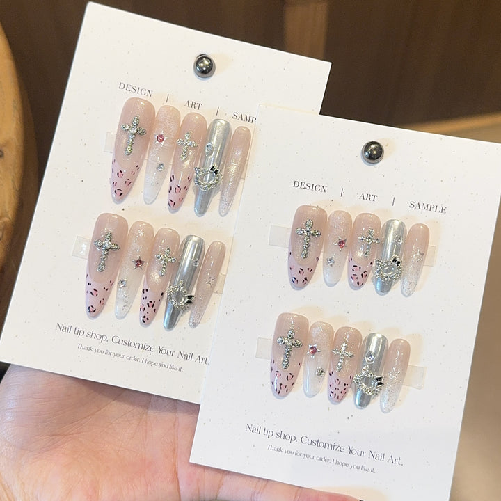 Artificial nails with sparkling rhinestones and cross motifs Bowlift