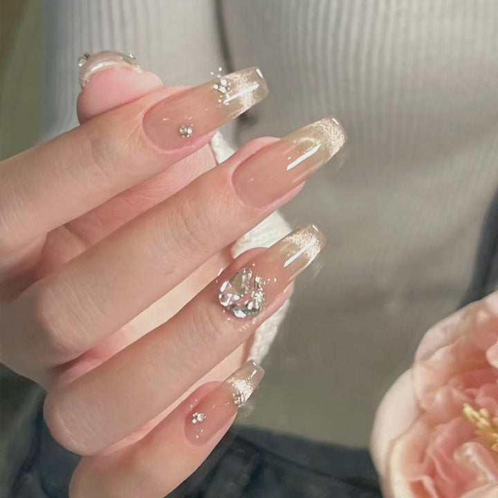 Acrylic nail set with glamorous glitter accents and elegant jewelry embellishments Bowlift